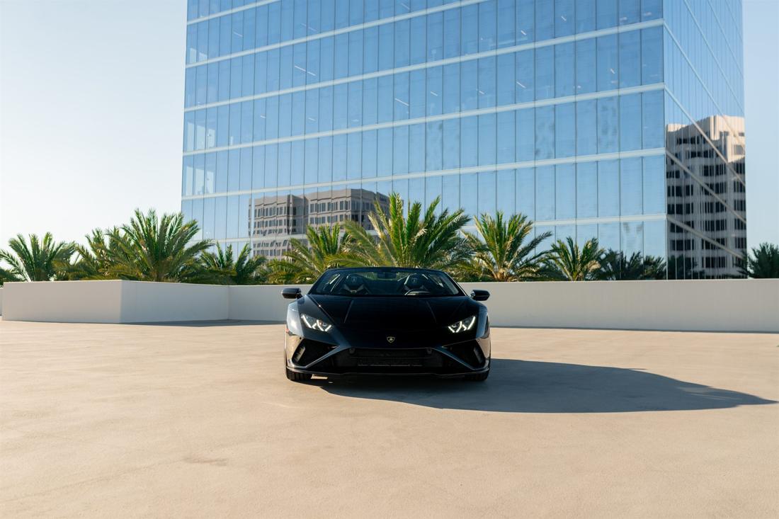 Black Lamborghini Huracán EVO Spyder with the top down, available for rent in Los Angeles